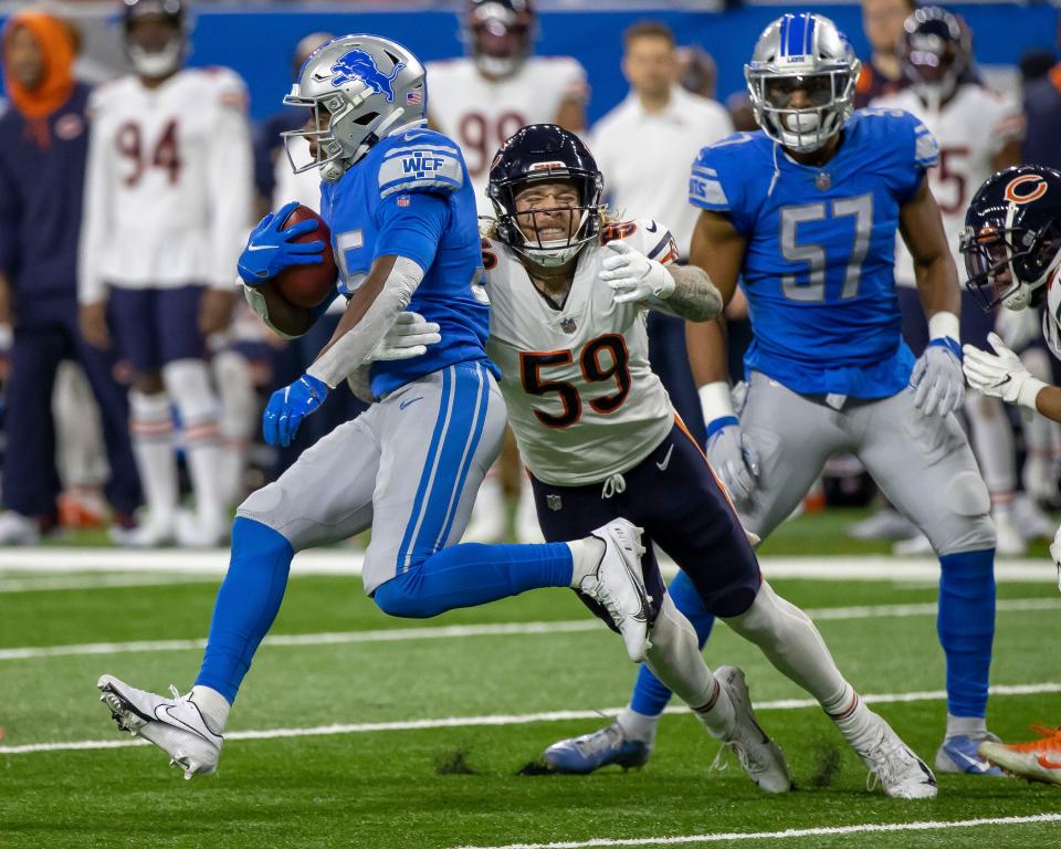 Detroit Lions running back Godwin Igwebuike (35) tries to avoid a tackle from Chicago Bears inside linebacker Danny Trevathan (59).