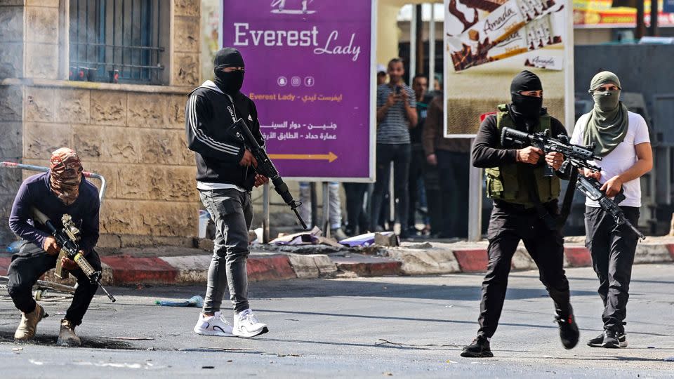 Palestinian armed militants take up positions during a clash with Israeli forces in Jenin on Monday. - Jaafar Ashtiyeh/AFP/Getty Images