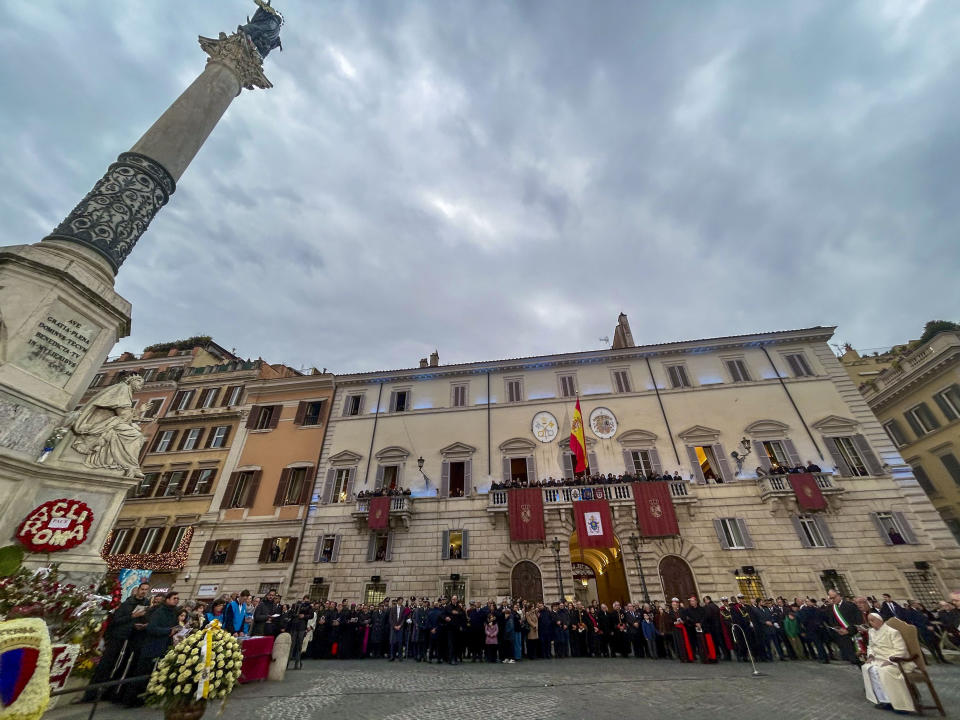 Pope Francis, right, is flanked by Rome's Mayor Roberto Gualtieri during his annual Christmas visit to venerate a statue of the Virgin Mary topping a monumental column, left, near the Spanish Steps in Rome. Friday, Dec. 8, 2023. (AP Photo/Gregorio Borgia)