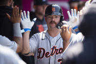 Detroit Tigers' Jake Rogers is greeted in the dugout after scoring on a two-run single by Miguel Cabrera during the fifth inning of a baseball game against the Los Angeles Angels in Anaheim, Calif., Sunday, June 20, 2021. (AP Photo/Kyusung Gong)
