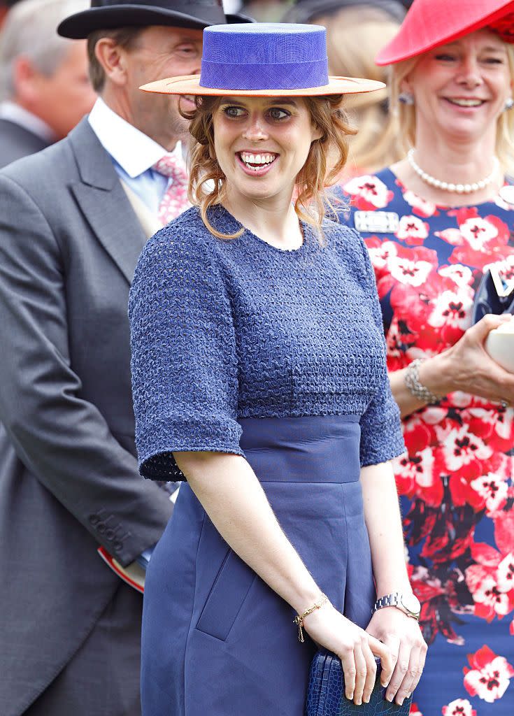 <p>Never one to shy away from a trend Princess Beatrice sported a wide brimmed, multi-colored hat and plain blue dress.</p>