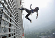 A student takes part in a practice session of a stunt performance at Tagou Wushu School in Zhengzhou, Henan province July 29, 2010. More than 1,500 students from the school will perform at the opening ceremony of the upcoming Asian Games to be held this November in Guangzhou, local media reported. Picture taken July 29, 2010. REUTERS/Donald Chan