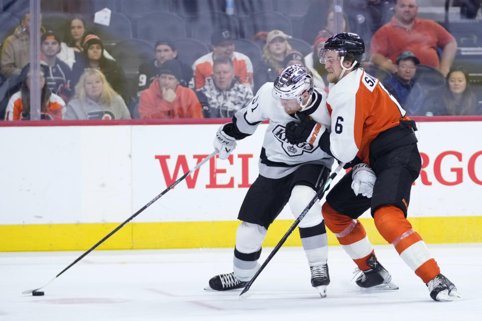Los Angeles Kings' Carl Grundstrom, left, and Philadelphia Flyers' Travis Sanheim battle for the puck during the third period of an NHL hockey game, Saturday, Nov. 4, 2023, in Philadelphia. (AP Photo/Matt Slocum)