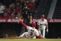 Los Angeles Angels' Taylor Ward (3) slides in to home to score off of a sacrifice fly hit by David MacKinnon during the fifth inning of a baseball game against the Kansas City Royals in Anaheim, Calif., Wednesday, June 22, 2022. (AP Photo/Ashley Landis)