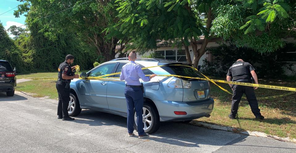 Melbourne police and detectives rope off the yard of a home on Tanglewood Lane in the Eau Gallie area after two people were discovered dead inside Aug. 16, 2022.