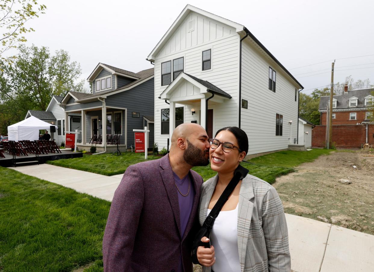Brandon and Nicole Liggins with their newly purchased home behind them, a 1,850-square-foot home that costs $459,000. The couple came to a news conference and ribbon-cutting ceremony for the Greatwater Opportunity Capital homes on Fischer Street in Detroit on Thursday, May 9, 2024.