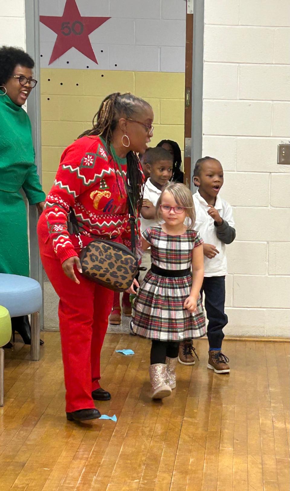 Formey Early Learning Center Principal Erica Swindell-Foster (foreground) and SCCPSS Deputy Superintendent Bernadette Ball-Oliver (background) welcome students into a classroom at Formey where bikes donated by Gateway Terminals awaited the students on Dec. 14, 2023.