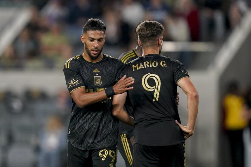 Los Angeles FC forward Denis Bouanga, left, greets forward Mario González.