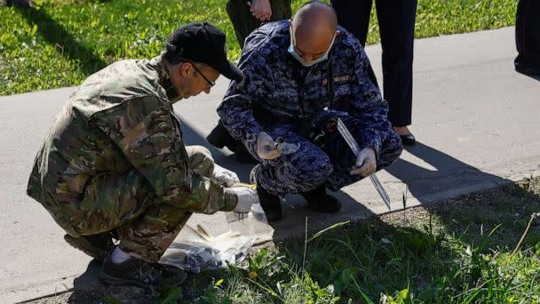 PHOTO: IInvestigators gather evidence while working outside a damaged multi-storey apartment block following a reported drone attack in Moscow, Russia, May 30, 2023. (Maxim Shemetov/Reuters)