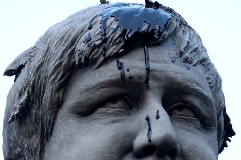 A statue depicting Britain?s Prime Minister Boris Johnson is seen stained with oil thrown by Greenpeace climate activists during a protest outside Downing Street, in London, Britain, October 11, 2021. REUTERS/Hannah McKay