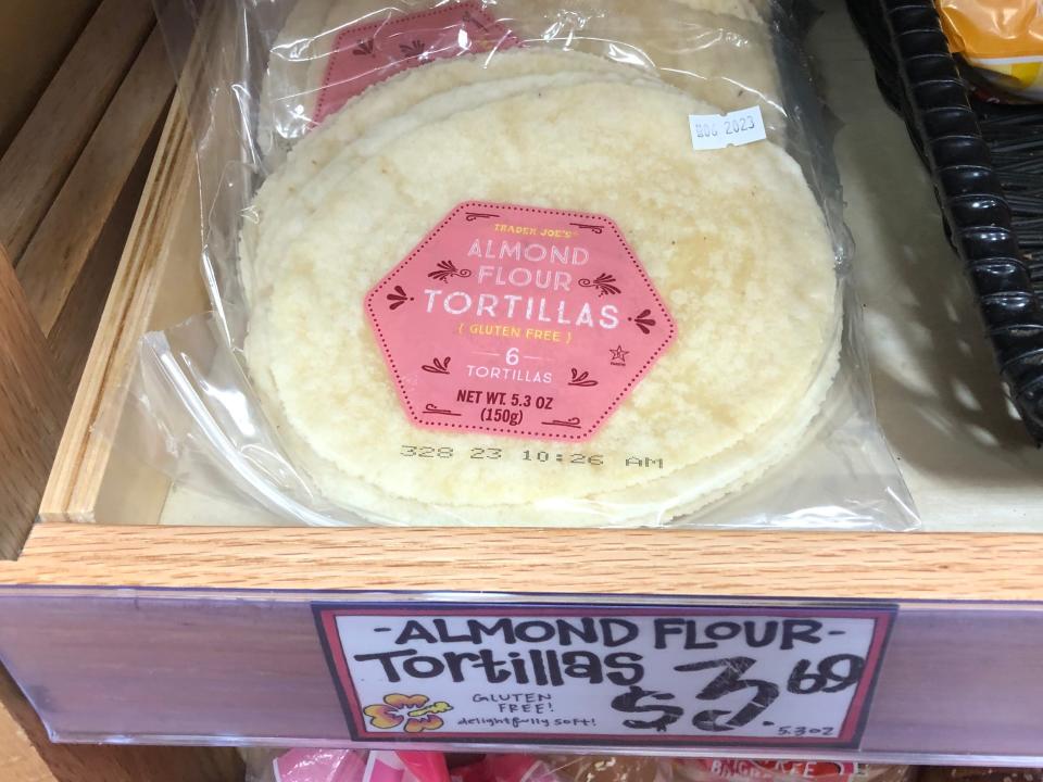 Bags of gluten-free almond-flour tortillas on display at Trader Joe's, with a price tag that reads $3.69.