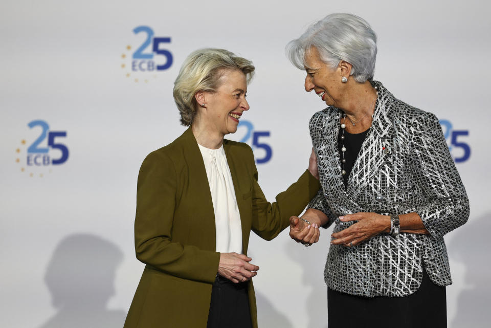 European Central Bank president Christine Lagarde, right, welcomes President of the European Commission Ursula von der Leyen during a ceremony to celebrate the 25th anniversary of the ECB, in Frankfurt, Germany, Wednesday May 24, 2023. (Kai Pfaffenbach/Pool via AP)