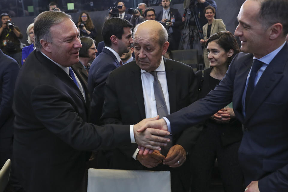 U.S. Secretary of State Mike Pompeo, left, shakes hands with Germany's Foreign Minister Heiko Maas, right, next to France's Foreign Minister Jean-Yves Le Drian during a NATO Foreign Ministers meeting at the NATO headquarters in Brussels, Wednesday, Nov. 20, 2019. (AP Photo/Francisco Seco)