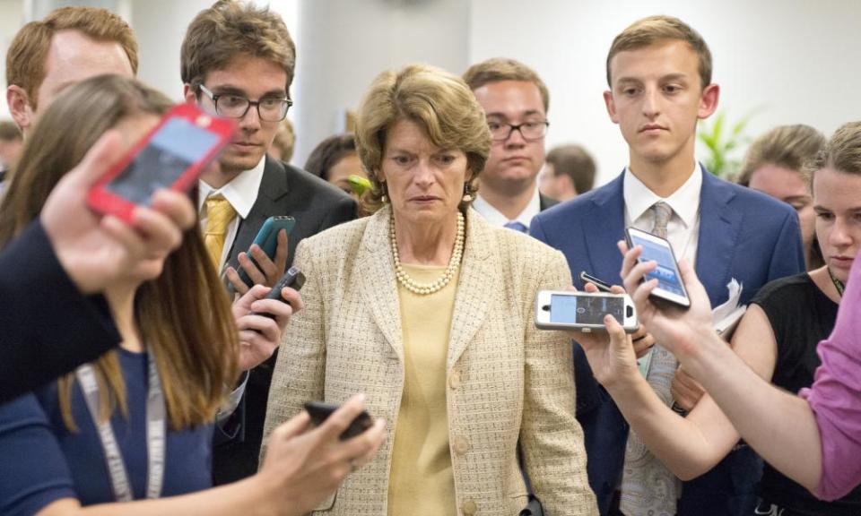 Senator Lisa Murkowski is surrounded by reporters as she arrives in the US Capitol prior to a vote on the repeal of the Affordable Care Act.