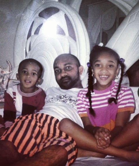 In this 1995 family photo provided by Jahmar Thomas, Nikiesha Thomas, right, her brother Jahmar Thomas, left, and father Gilbert Thomas, smile for a photo in Olney, Md. Nikiesha Thomas was shot and killed by her ex-boyfriend just days after filing for a protective order last October. Victims of abuse and their families saw a quiet breakthrough this summer when the passage of a bipartisan gun safety bill in Congress included a proposal that would make it more difficult for intimate partners of convicted domestic abusers to obtain firearms. (Jahmar Thomas via AP)