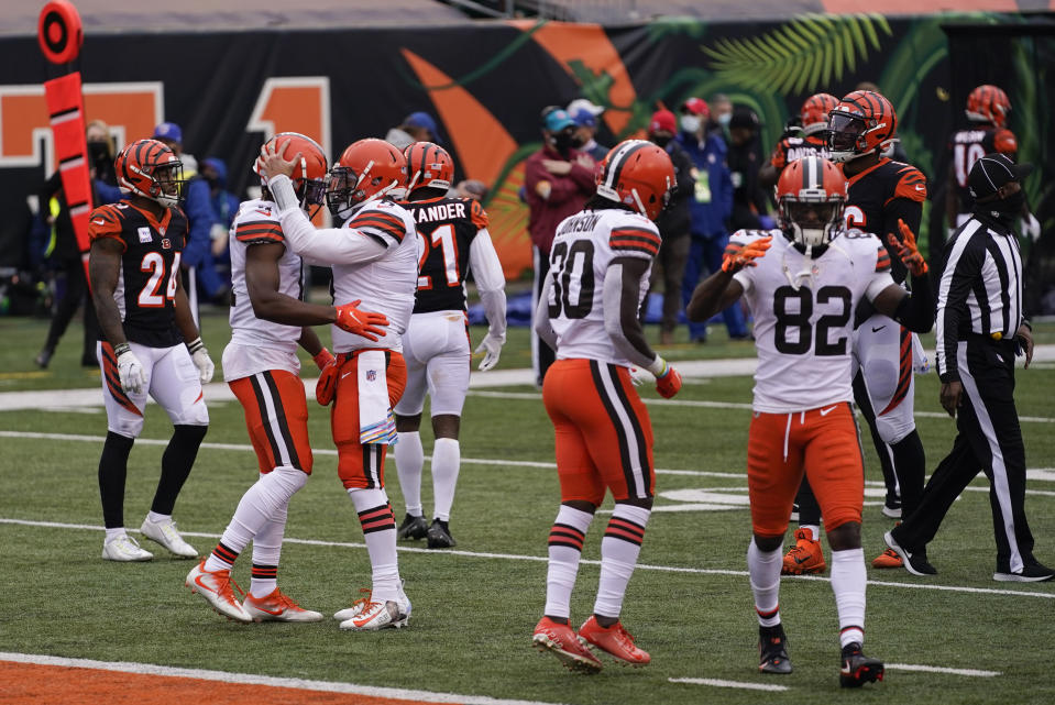 Cleveland Browns quarterback Baker Mayfield (6) talks with wide receiver Donovan Peoples-Jones after Peoples-Jones' touchdown reception during the second half of an NFL football game against the Cincinnati Bengals, Sunday, Oct. 25, 2020, in Cincinnati. (AP Photo/Bryan Woolston)