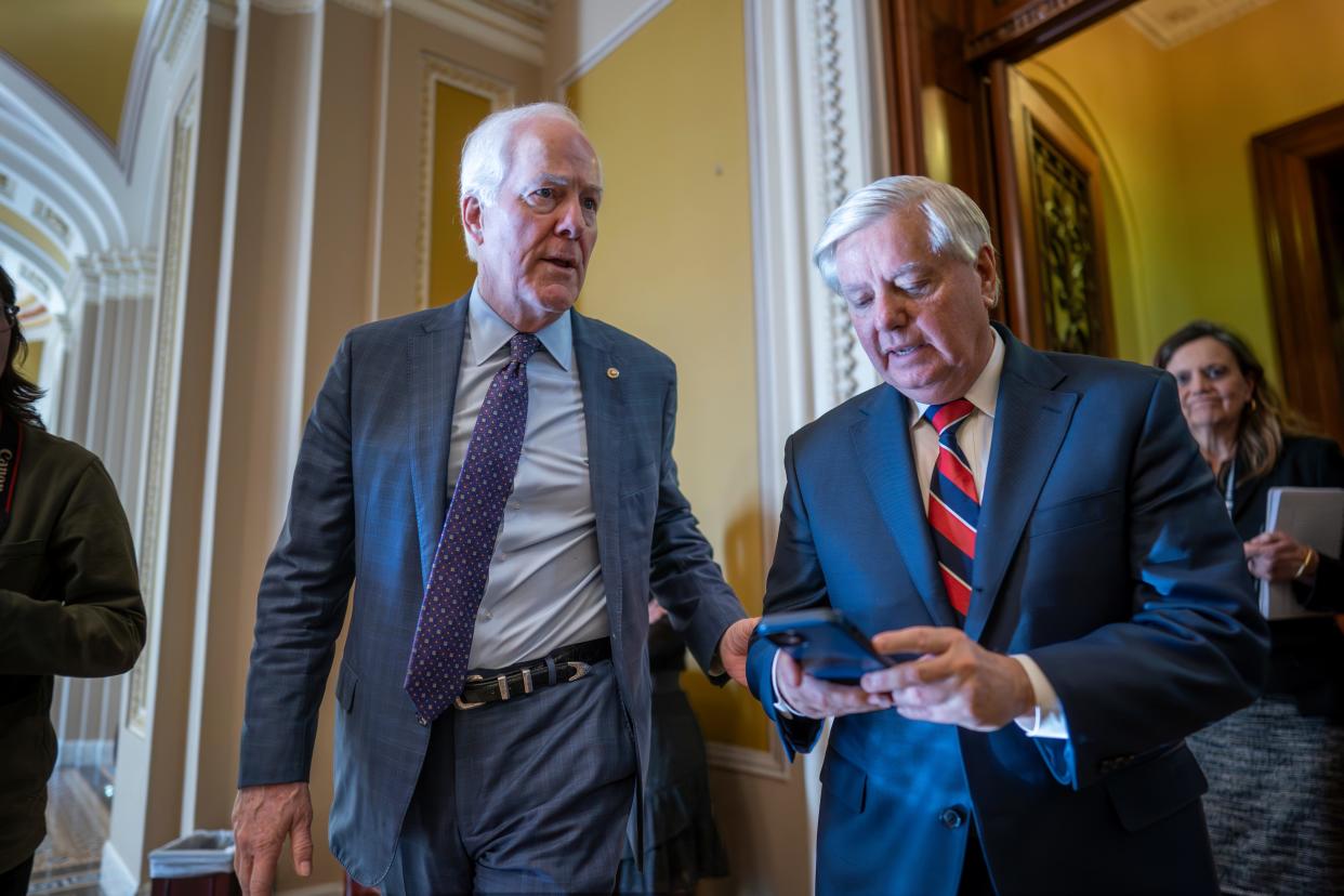 Sen. John Cornyn, R-Texas, left, talks with Sen. Lindsey Graham, R-S.C., outside the chamber during a vote at the Capitol in Washington in February.