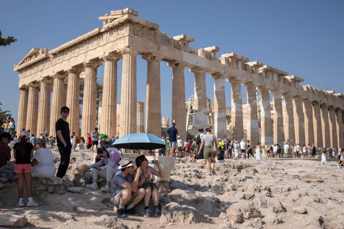 Tourists in front of the Parthenon temple at the Acropolis in Athens   (AP)