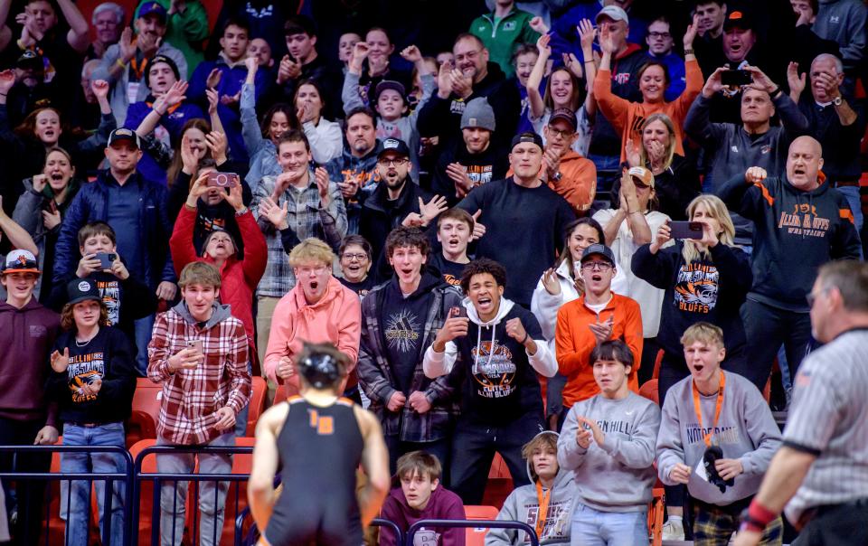 Fans cheer on Illini Bluffs' Jackson Carroll after his 8-7 decision over Unity's Kaden Inman in the 144-pound match of the Class 1A state wrestling championships Saturday, Feb. 17, 2024 at the State Farm Center in Champaign.