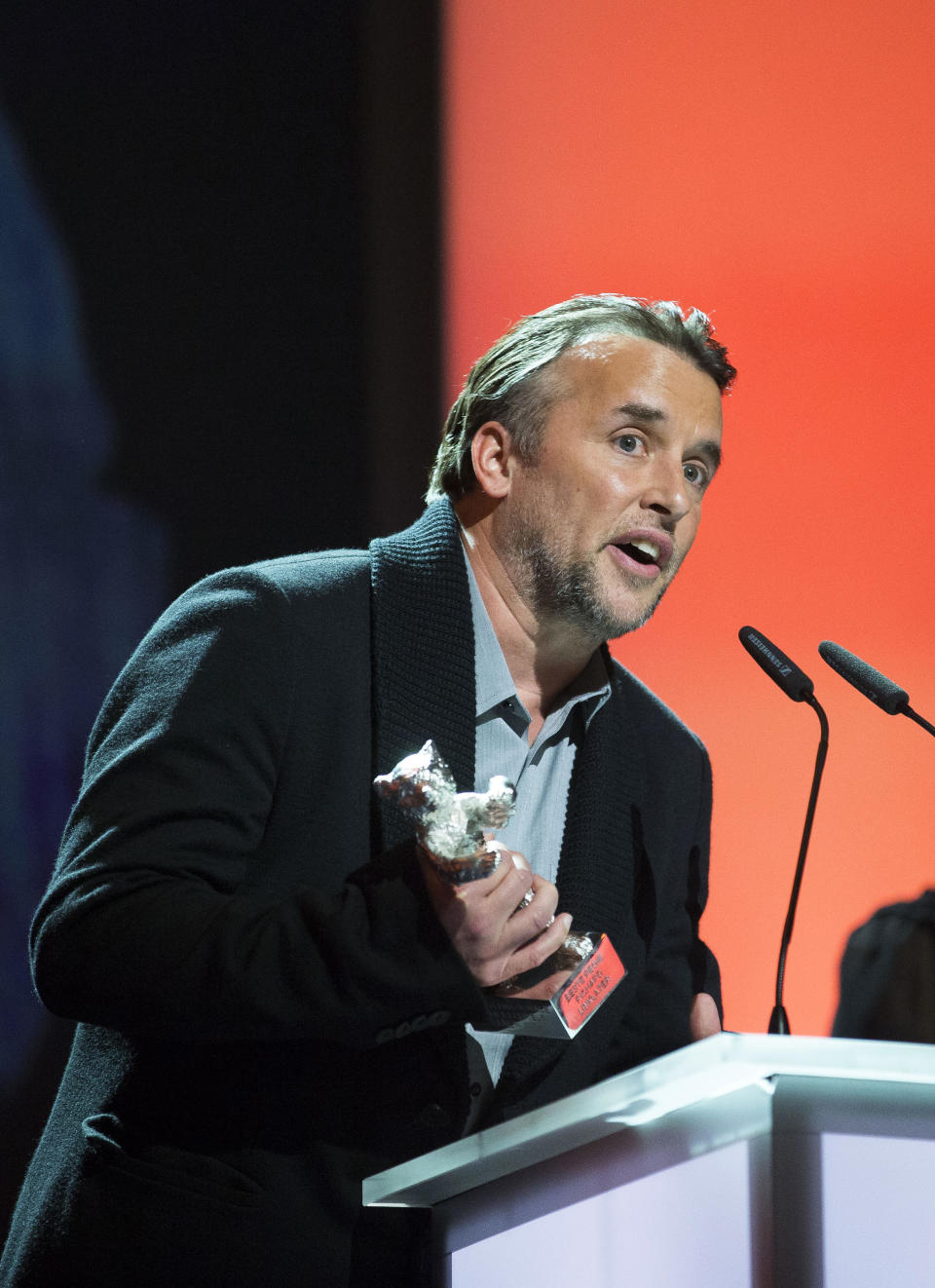 Richard Linklater receives the Silver Bear for Best Director for the movie Boyhood during the award ceremony at the International Film Festival Berlinale in Berlin, Saturday, Jan. 15, 2014. (AP Photo/Axel Schmidt)