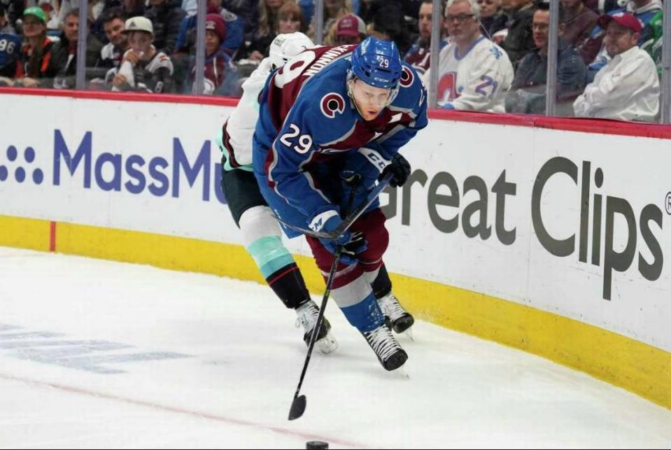 Seattle Kraken defenseman Will Borgen pressures Colorado Avalanche center Nathan MacKinnon (29) during the first period of Game 2 in a first-round Stanley Cup playoff series Thursday, April 20, 2023, in Denver.