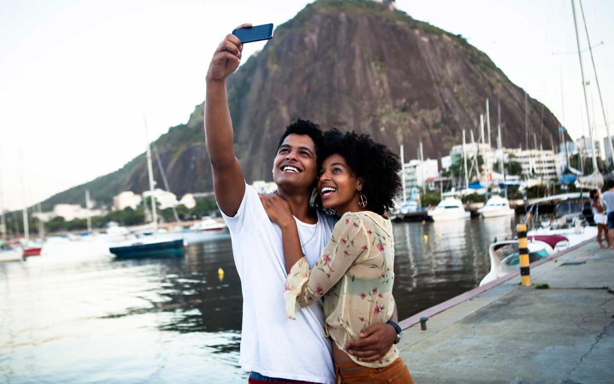 Couple taking a selfie by boats