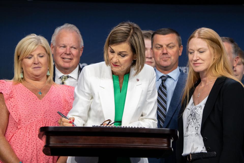 Governor Kim Reynolds signs a 6-week 'fetal heartbeat' abortion ban during the Family Leadership Summit in Des Moines, Friday, July 14, 2023. 