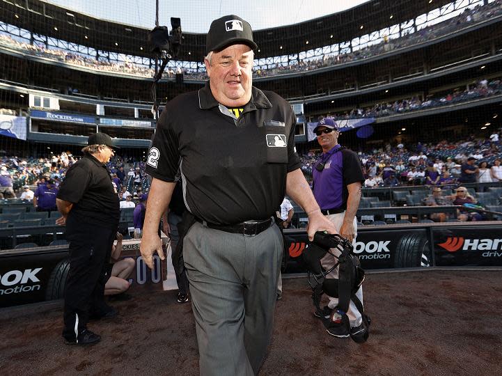 Joe West, who recently umpired his 5,00th career game, avoided injury after being hit in the head by a baseball thrown from the stands. (AP)