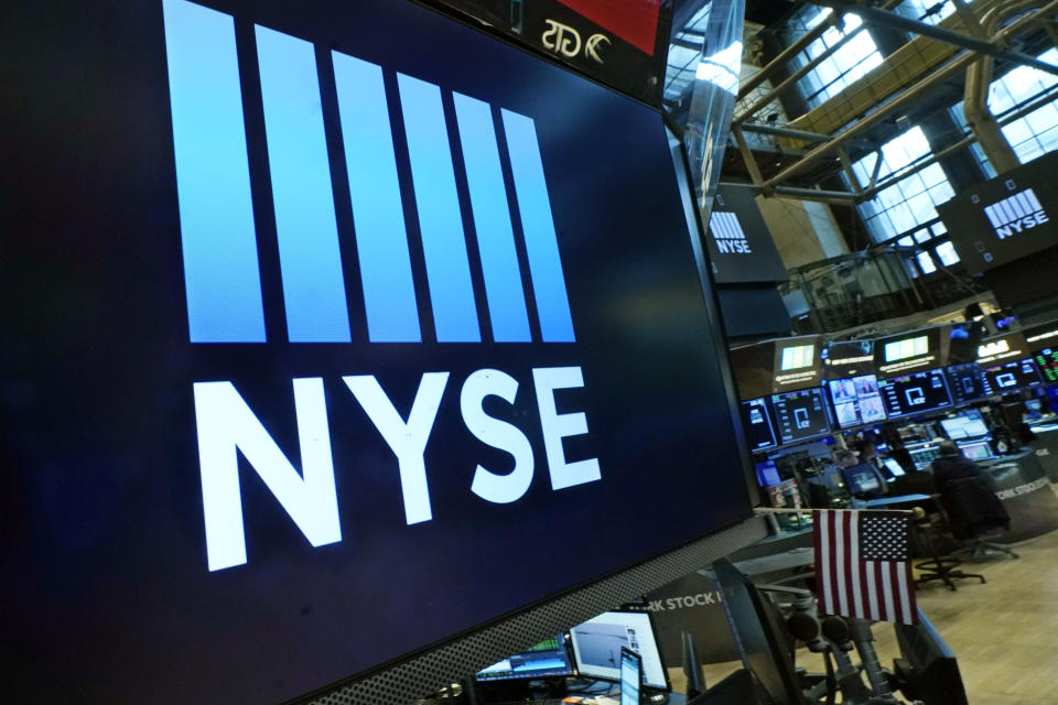 FILE - Logos the New York Stock Exchange adorn trading posts, on the floor, Wednesday, March 16, 2022. (AP Photo/Richard Drew, File)