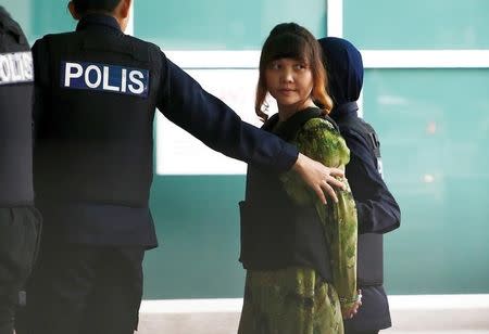 Vietnamese Doan Thi Huong who is on trial for the killing of Kim Jong Nam, the estranged half-brother of North Korea's leader, is escorted as she arrives at the Department of Chemistry in Petaling Jaya, near Kuala Lumpur, Malaysia October 9, 2017. REUTERS/Lai Seng Sin/Files