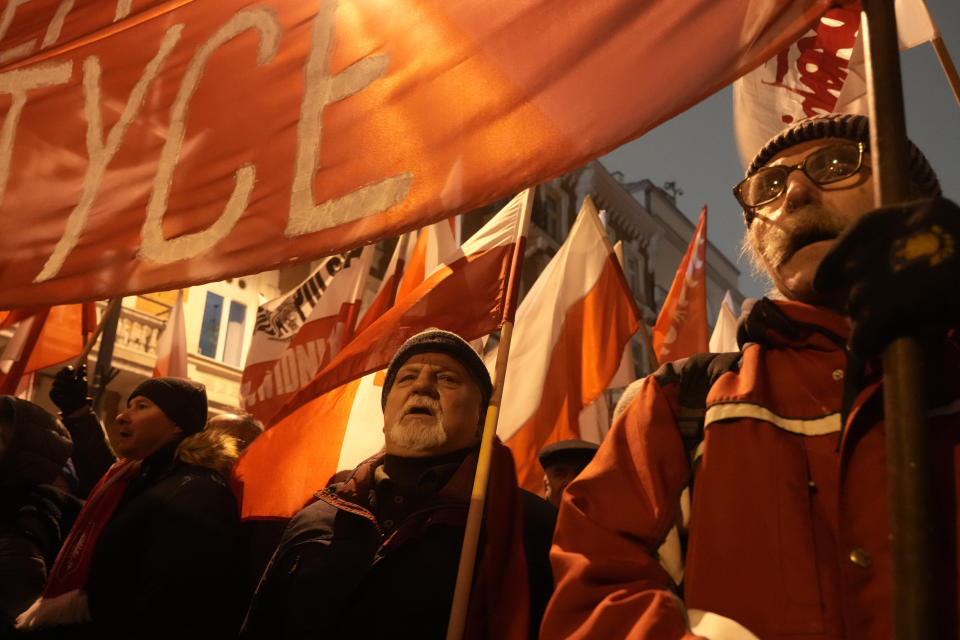 Supporters of right-wing Law and Justice party protest before the parliament building in Warsaw, Poland, on Thursday, Jan. 11, 2024. Law and Justice, frustrated over its recent loss of power, urged its supporters to protest moves by the new pro-European Union government to take control of state media. It also said it was protesting the arrests Tuesday of two senior members of Law and Justice, former Interior Minister Mariusz Kaminski and his former deputy, Maciej Wasik. (AP Photo/Czarek Sokolowski)