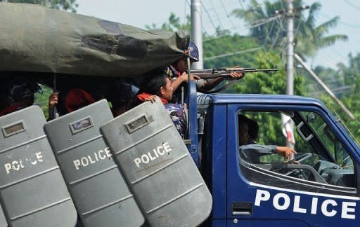 Myanmar police patrol the streets of Sittwe, the capital of the western state of Rakhine. Dozens of people have been killed in a surge in sectarian violence in Myanmar, as international pressure grew for an end to the bloodshed