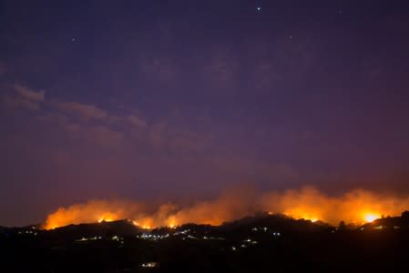 Flames and smoke from a forest fire are seen in the village of Moya in the Canary Island of Gran Canaria