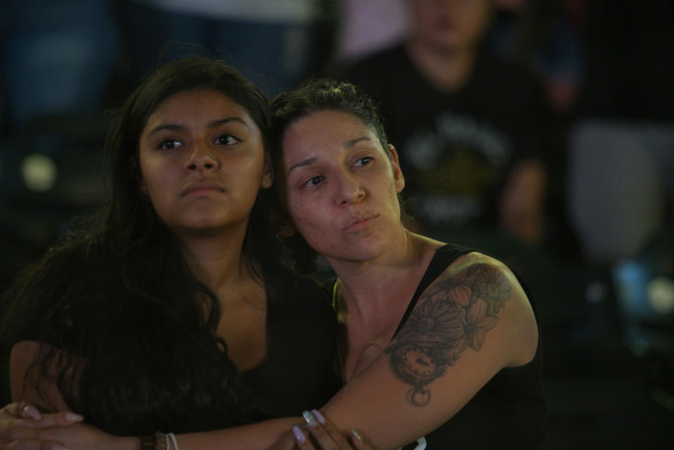 Mourners listen to "Amor Eterno" performed by mariachis during a community memorial service, Wednesday, Aug. 14, 2019, at Southwest University Park, in El Paso, Texas, for the people killed in a mass shooting on Aug. 3. (AP Photo/Jorge Salgado)