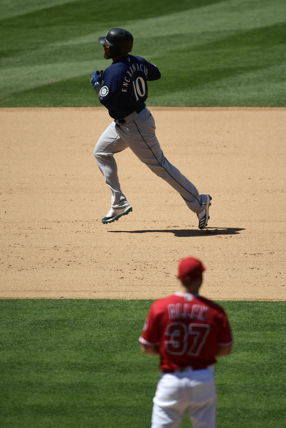 Seattle Mariners' Edwin Encarnacion, top, heads to third after hitting a solo home run as Los Angeles Angels relief pitcher Cody Allen watches during the sixth inning of a baseball game Sunday, June 9, 2019, in Anaheim, Calif. (AP Photo/Mark J. Terrill)