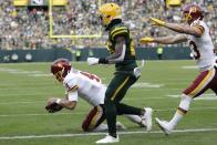 Washington Football Team's Taylor Heinicke is down short of the goal line on a run during the second half of an NFL football game against the Green Bay Packers Sunday, Oct. 24, 2021, in Green Bay, Wis. (AP Photo/Aaron Gash)