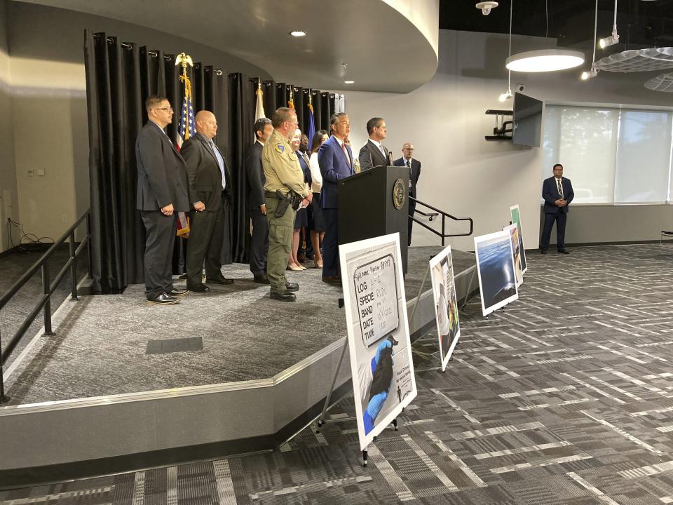 California Attorney General, in center at podium, flanked by Orange County District Attorney Todd Spitzer, right of Bonta, announce that a plea agreement has been reached with an oil company and two of its subsidiaries for the negligent discharging of crude oil, during a news conference in Santa Ana, Calif., Thursday, Sept. 8, 2022. Amplify Energy and two of its subsidiaries each pleaded guilty to a misdemeanor charge for negligently discharging oil off the Southern California coast in connection with a pipeline break that covered beaches with blobs of crude. (AP Photo/Amy Taxin)