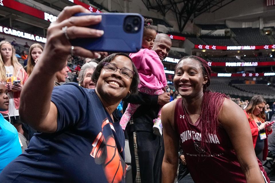 South Carolina's Aliyah Boston takes a selfie with a fan Thursday after a practice session for the NCAA Women's Final Four.