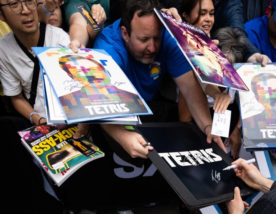 A gathered crowd scrambles to get autographs from Taron Egerton, who plays Henk Rogers in "Tetris," before he walks the red carpet for the film's premiere during South by Southwest on March 15 at the Paramount Theatre.