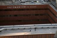 Protesters are seen on a rooftop of the Hong Kong Polytechnic University (PolyU), in Hong Kong