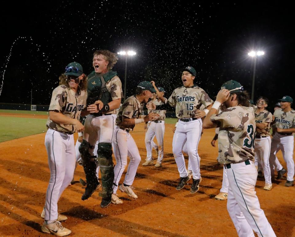 Members of the Island Coast Gators baseball team celebrate after defeating Miami Springs 4-1 in the  Class 4A-Region 4 Championship game Tuesday, May 17, 2022. The Gators move on to the state semi-finals game. 