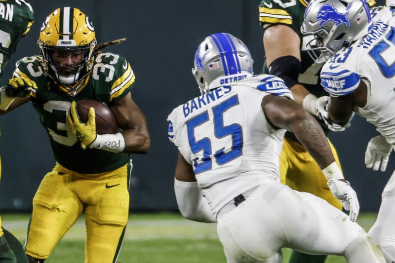 Green Bay Packers running back Aaron Jones (L) runs against the Detroit Lions on Thursday at Lambeau Field in Green Bay, Wis. Photo by Tannen Maury/UPI