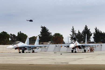 Sukhoi Su-30 fighter jets are seen on the tarmac at the Hmeymim air base near Latakia, Syria, in this handout photograph released by Russia's Defence Ministry on October 22, 2015. REUTERS/Ministry of Defence of the Russian Federation/Handout via Reuters