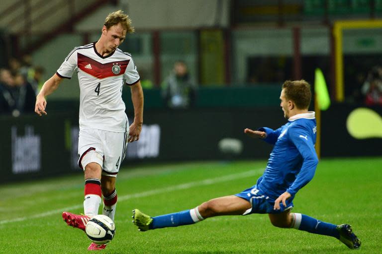 Germany defender Benedikt Hoewedes (left) outpaces Italy's Domenico Criscito during a friendly on November 15, 2013 at the San Siro stadium in Milan