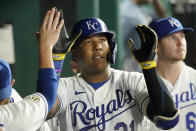 Kansas City Royals' Salvador Perez celebrates in the dugout after hitting a solo home run during the fifth inning of a baseball game against the Oakland Athletics Wednesday, Sept. 15, 2021, in Kansas City, Mo. (AP Photo/Charlie Riedel)