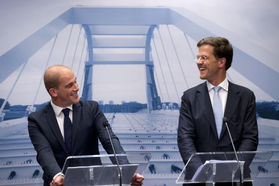 Caretaker Prime Minister Mark Rutte, right, and Labor Party Leader Diederik Samsom, left, are seen in front of a picture symbolizing the theme of the new government, "building bridges", during a joint press conference in The Hague, Netherlands, Monday Oct. 29, 2012. The Netherlands is close to getting a new coalition government after lawmakers from the two biggest parties approved a policy deal hammered out by their leaders. Rutte, leader of the pro-free market VVD party, and center-left Labor Party chief Samsom have been negotiating behind closed doors for weeks to resolve policies for their proposed coalition. (AP Photo/Peter Dejong)