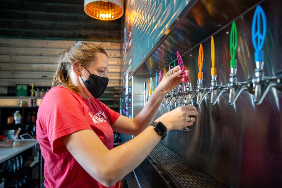 Bartender Rebecca Vieker pours a beer at Peace Tree Brewing in Des Moines. The brewery is hosting its fifth anniversary party on New Year's Day.
