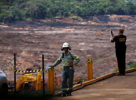 A federal police officer takes picture of the collapsed Brazilian mining company Vale SA, in Brumadinho, Brazil February 1, 2019. REUTERS/Adriano Machado
