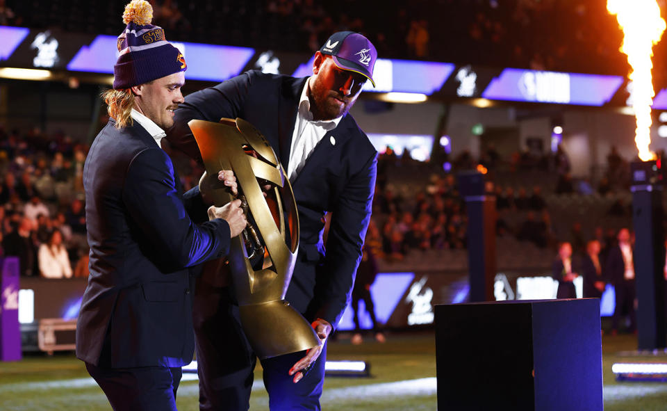 Ryan Papenhuyzen and Nelson Asofa-Solomona with the 2020 premiership trophy. 