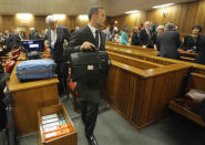 Oscar Pistorius, leaves court at the end the second day of his trial at the high court in Pretoria, South Africa, Tuesday, March 4, 2014. Pistorius is charged with murder for the shooting death of his girlfriend, Reeva Steenkamp, on Valentines Day in 2013. (AP Photo/Kim Ludbrook,Pool)